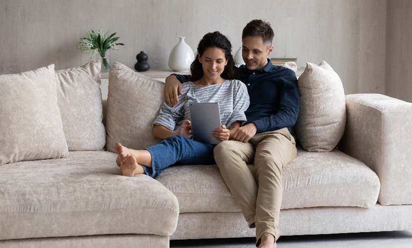 A couple controlling their smart home from a tablet